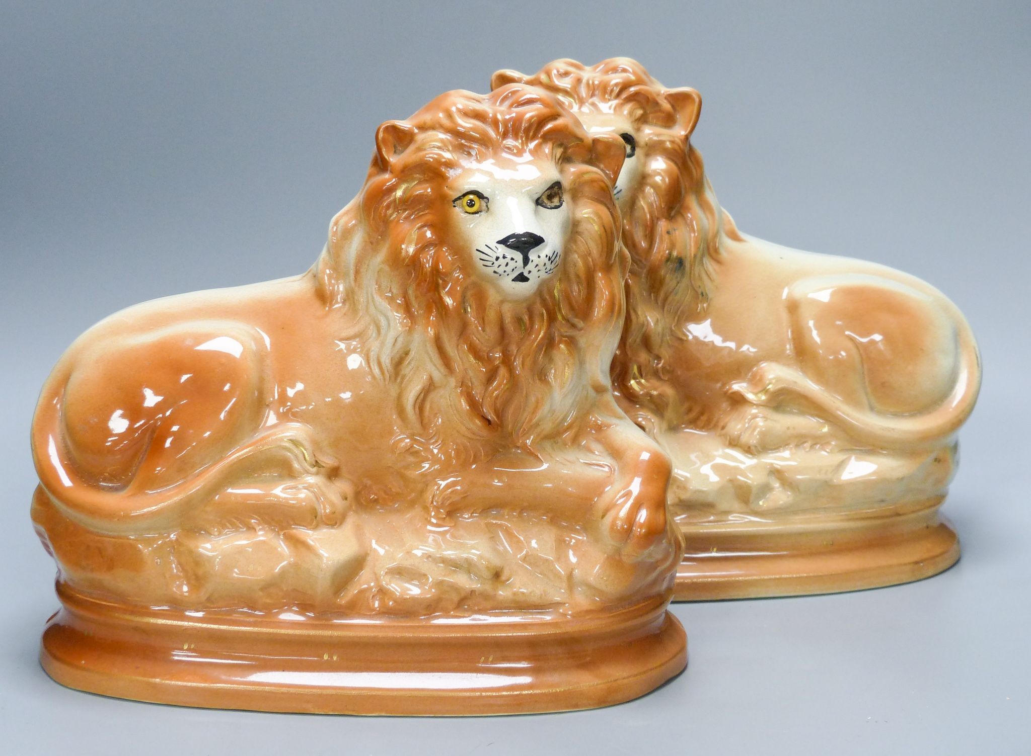 A pair of Staffordshire pottery 'lion' figures 30cm